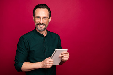 Poster - Photo of cheerful positive handsome attractive man holding copybook for writing down interesting information from you isolated vivid color background