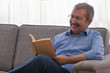 © IndiaPix - Portrait of a senior man sitting at home and reading a book.
