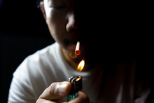 Asian Men Are Lit A Cigarette To Smoke.