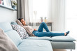 © leszekglasner - Relaxed asian girl lying on sofa at home in calm leisure time