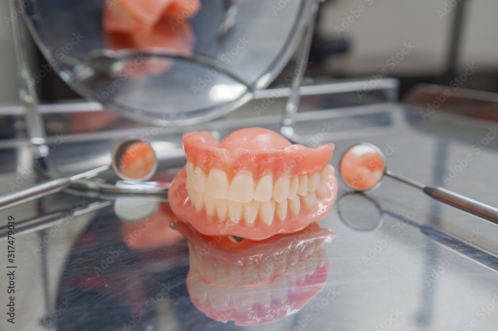 Set of dentures and dental tools. Close up Teeth and dental mirror ...
