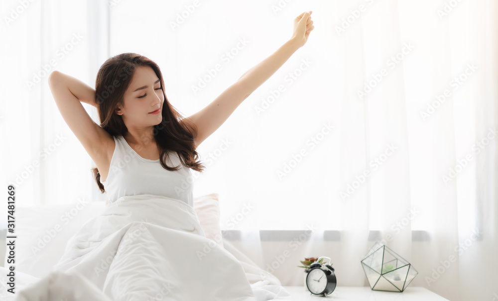 Woman stretching happy and relaxed after wake up in the morning at home - obrazy, fototapety, plakaty 