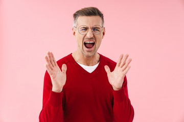 Poster - Portrait of handsome caucasian man screaming and raising hands