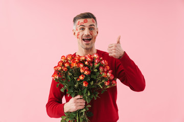 Poster - Portrait of man with kiss marks holding flowers on valentines day