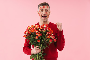 Poster - Portrait of man with kiss marks holding flowers on valentines day