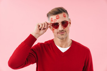 Wall Mural - Portrait of man with kiss marks at his wearing heart-shaped sunglasses