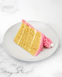 © Sharon Cosgrove - Vanilla cake slice with pink frosting on plate