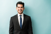 Handsome Hispanic Businessman In Black Suit At Studio