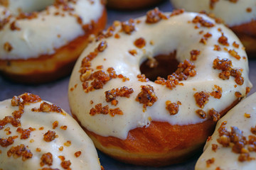 Wall Mural - Fresh pumpkin donuts with white icing