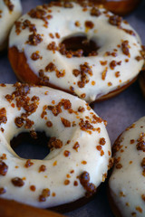 Wall Mural - Fresh pumpkin donuts with white icing