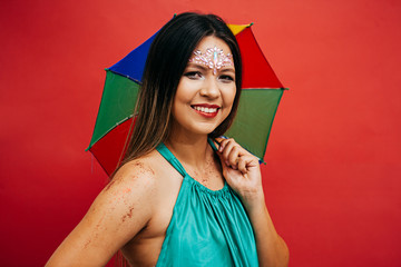 Wall Mural - Young woman celebrating the Brazilian carnival party with Frevo umbrella