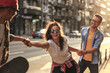 © BalanceFormCreative - Group of friends hangout at the city street.They hold hands and laughing.