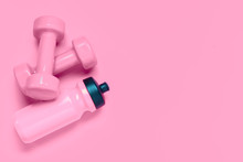 Fitness Workout Background Concept With Pink Dumbbells And Bottle Of Water. Top View Flatlay Sport, Diet And Healthy Lifestyle With Training Equipment On Pink Background With Blank Copy Space.