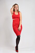 © Вячеслав Чичаев - A photo of a pretty smiling girl with long hair and excellent make-up in a red dress is standing in various poses in the studio. Universal concept vertical woman portrait on a white background.