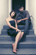 © Wrangler - Happy young couple sitting on the steps at aparment