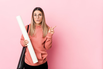 Young woman studying architecture pointing to the side