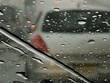 Raindrops on the glass, from the car in traffic