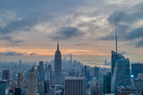 Fototapeta Nowy Jork - New York skyline from The Top of The Rock at sunset with clouds in the sky in the background