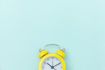 Ringing twin bell vintage classic alarm clock Isolated on blue colourful trendy pastel background. Rest hours time of life good morning night wake up awake concept. Flat lay top view copy space.