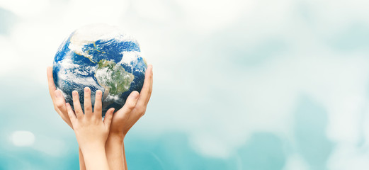 Wall Mural - Earth globe in family hands. World environment day. Elements of this image furnished by NASA.