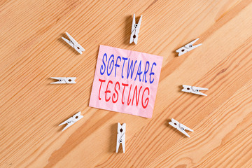Writing note showing Software Testing. Business concept for evaluate the functionality of a software application Colored clothespin papers empty reminder wooden floor background office