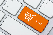 Online Shopping / Ecommerce And Retail Sale Concept : White Basket For Checkout, Shopping Cart Symbol On A Laptop Keyboard, Depicts Customers Order / Buy Things From Retailer Sites Using The Internet