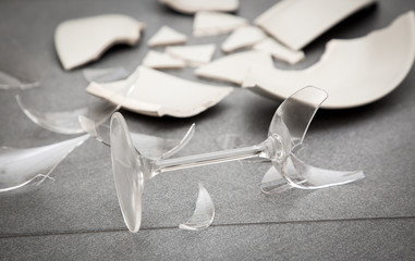 Broken Plate or broken water glass on the on the floor in the kitchen The concept of accidents in the kitchen is dangerous for the body and young children inside the house.