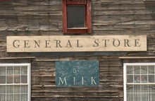 General Store Sign On A Wooden Building Alongside With Ice-cold Milk Sign Under The Sunlight
