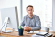 © marvent - Serious young businessman at his desk looking at the camera