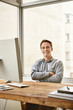 © marvent - Smiling businessman looking confident with his arms folded