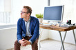 © marvent - Young creative professional in his office looking away