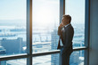 © marvent - Mature executive talking on phone at large office window