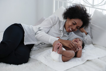 african american mother spend time with her baby boy at home