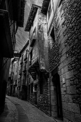 Wall Mural - Narrow medieval alley way with passage made of terracotta red stone in Albarracin Spain