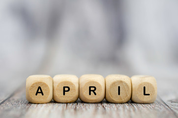 the word april on wooden cubes. month of year