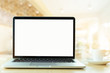 © panitan - mockup image blank screen computer with white background for advertising text,hand man using laptop contact business search information on desk at coffee shop.marketing and creative design