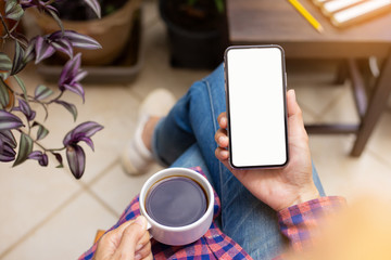 Mockup image blank white screen cell phone.man hand holding texting using mobile on desk at coffee shop.background empty space for advertise text.people contact marketing business,technology 