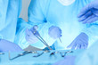 © rogerphoto - Close-up of medical team performing operation. Group of surgeons at work are busy of patient. Medicine, veterinary or healthcare and emergency in hospital
