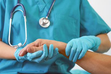 Doctor holding patient hand, examination of patients in the hospital. Surgeon, surgical doctor, anesthetist holding hand patient. Professional surgery, therapy, medical recovery concept.