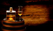 Whiskey bottle and whiskey glass stand on a whiskey barrel, whiskey drink in the distillery