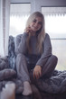 © kichigin19 - home coziness girl plaid window, home autumn look, model in a warm knitted blanket heats up