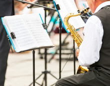 Close - Up Of Musicians Playing In Outerwear On The Street