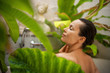 © Nejron Photo - Woman relaxing in outdoor bath with tropical leaves at Bali