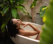 © Nejron Photo - Woman relaxing in outdoor bath with tropical leaves at Bali