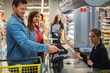 © Nejron Photo - Couple buying goods in a grocery store