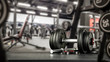 © magdal3na - Black desk of free space for your decoration and blurred gym interior.Metal dumbbells and fit life