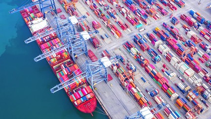 Wall Mural - 4K Time lapse industrial port with containers from top view or aerial view. It is an import and export cargo port where is a part of shipping dock