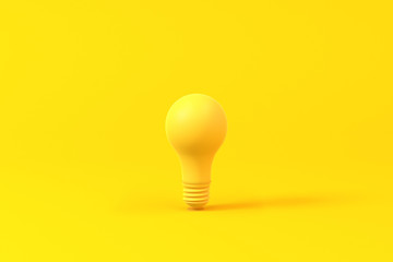 Light bulb isolated over a yellow background. Minimalist concept.