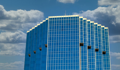 Poster - A blue glass office tower against a blue sky