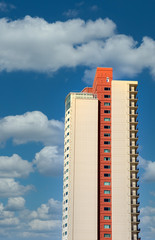 Poster - A high rise condo tower against blue sky